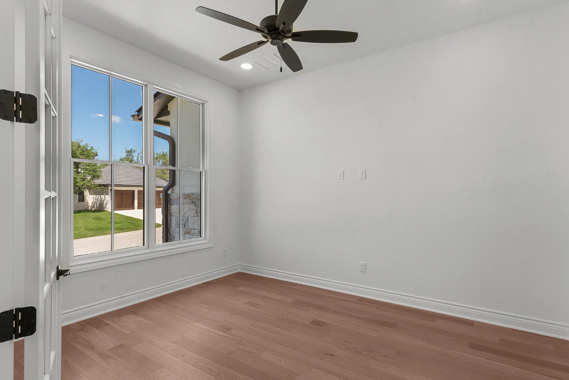 Office with hardwood floors and natural light